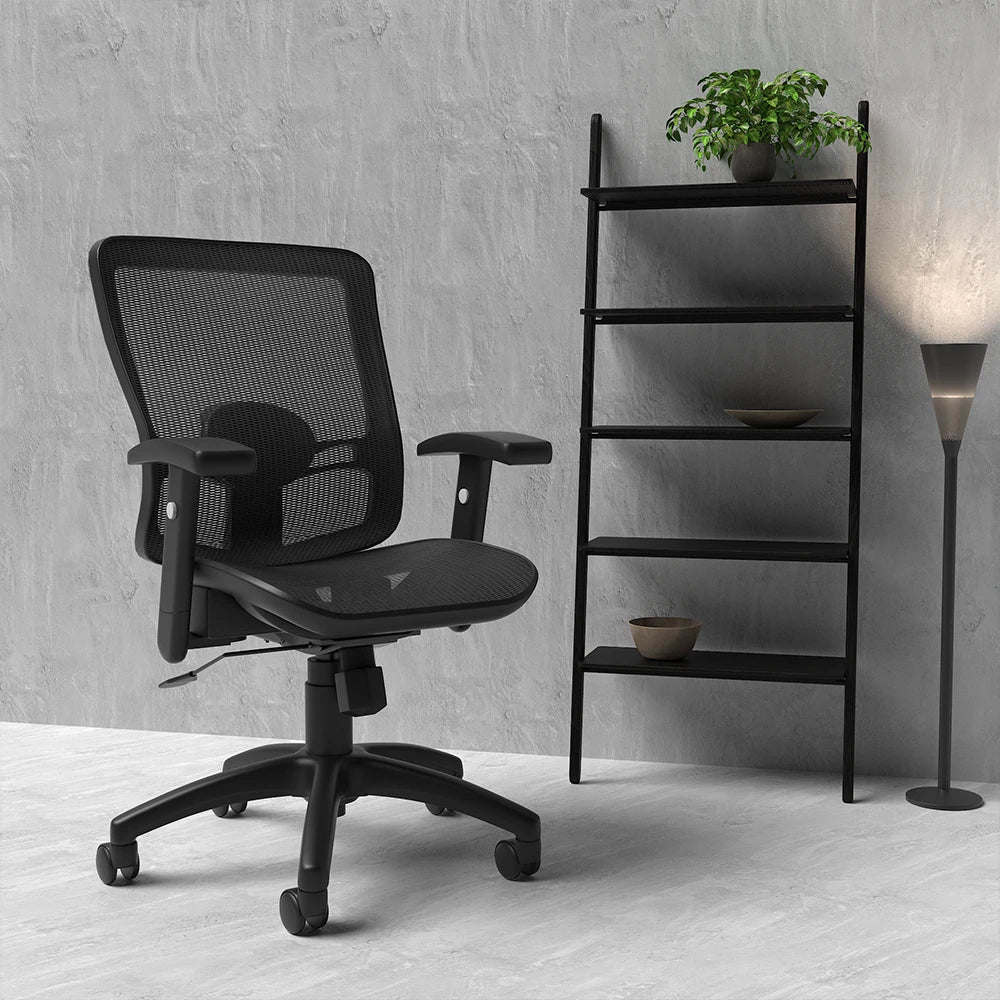 Black mesh chair on a grey floor with shelves and lamp in the background
