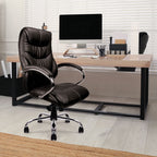Black office chair in front of a wooden desk with a computer setup.