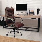 Brown leather office chair in front of a desk with a computer setup.