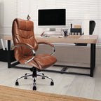 Tan brown leather office chair in front of a desk with a computer setup.