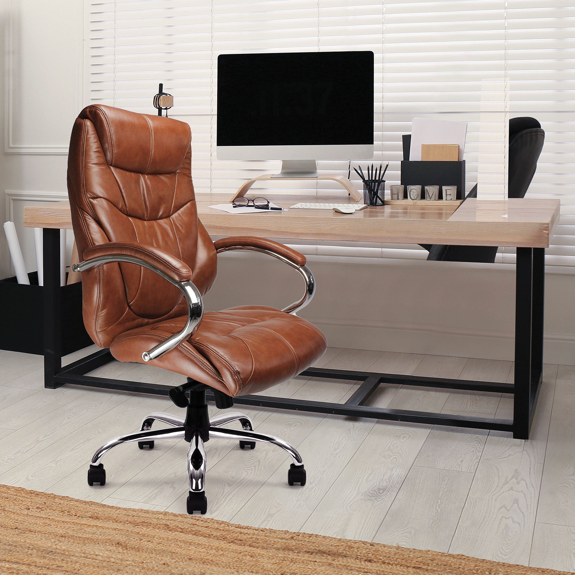 Tan brown leather office chair in front of a desk with a computer setup.