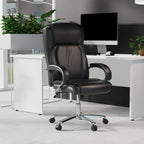 Black office chair in an office setting with a desk and computer monitor.