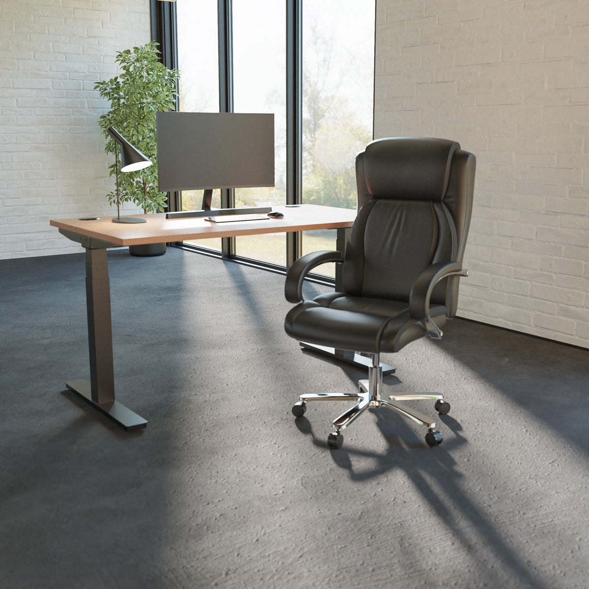Modern office desk with a leather chair and computer setup in a bright room.