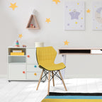 Children's room with a yellow chair, white desk, and star decorations on the wall.