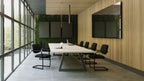 Modern conference room with a large table and chairs near large windows.