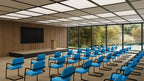Modern conference room with blue chairs and a large window view.