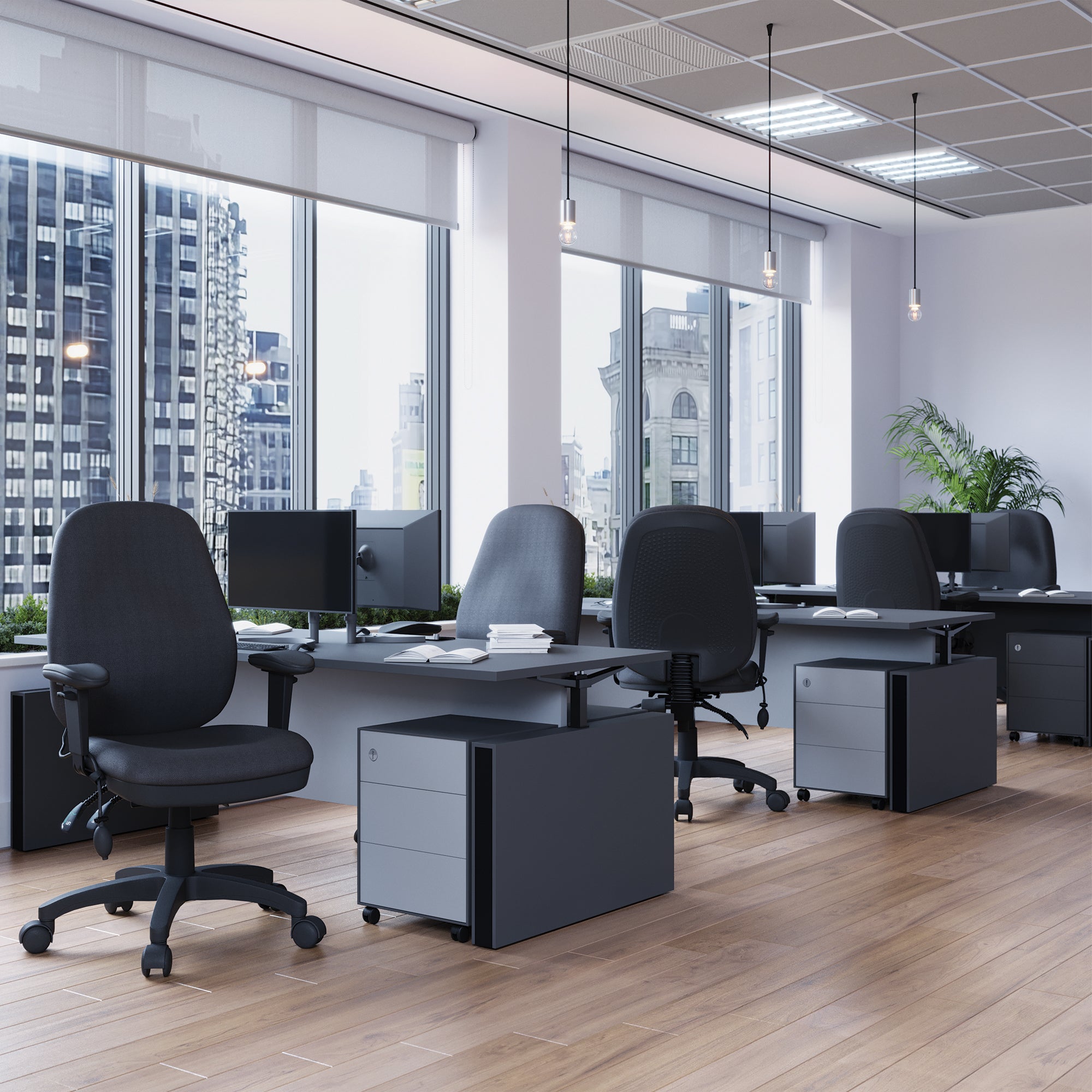 Modern office setup with desks, chairs, and large windows overlooking a cityscape.