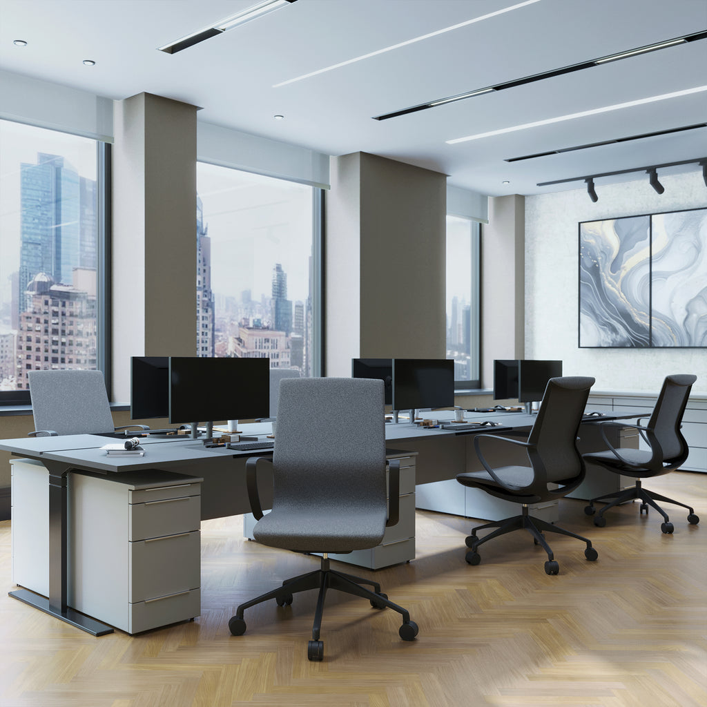 Modern office space with desks, chairs, and large windows overlooking a cityscape.