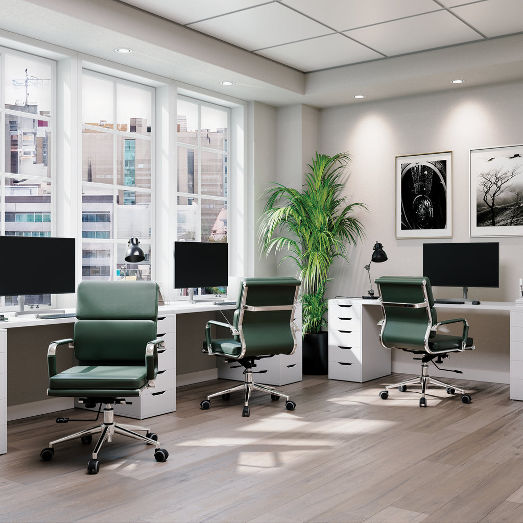 Modern office with green chairs, desks, and large windows.