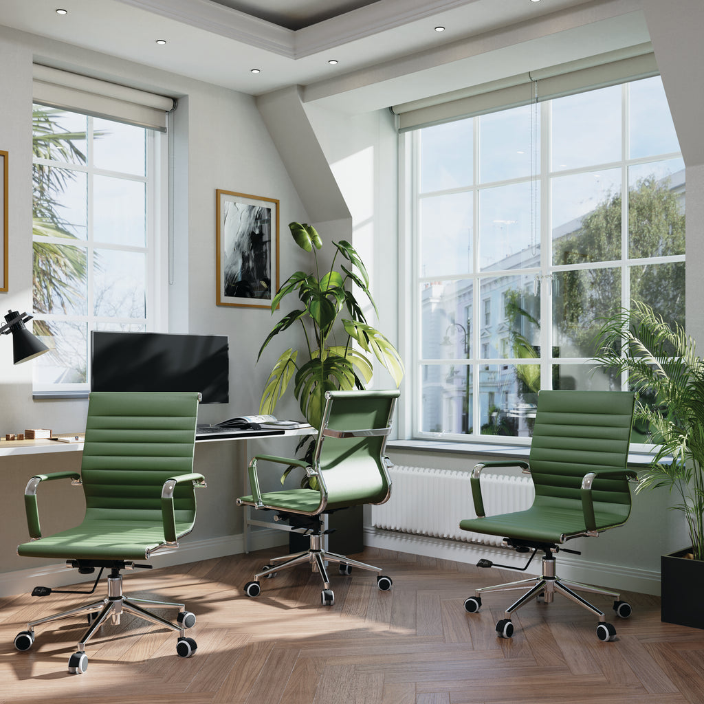 Modern office with green chairs, desk, and large windows.