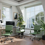 Modern office with green chairs, desk, and large windows.