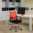 Orange office chair in front of a desk with a computer setup in an office setting.