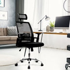 Black office chair in a modern living room setting with a desk and computer monitor.