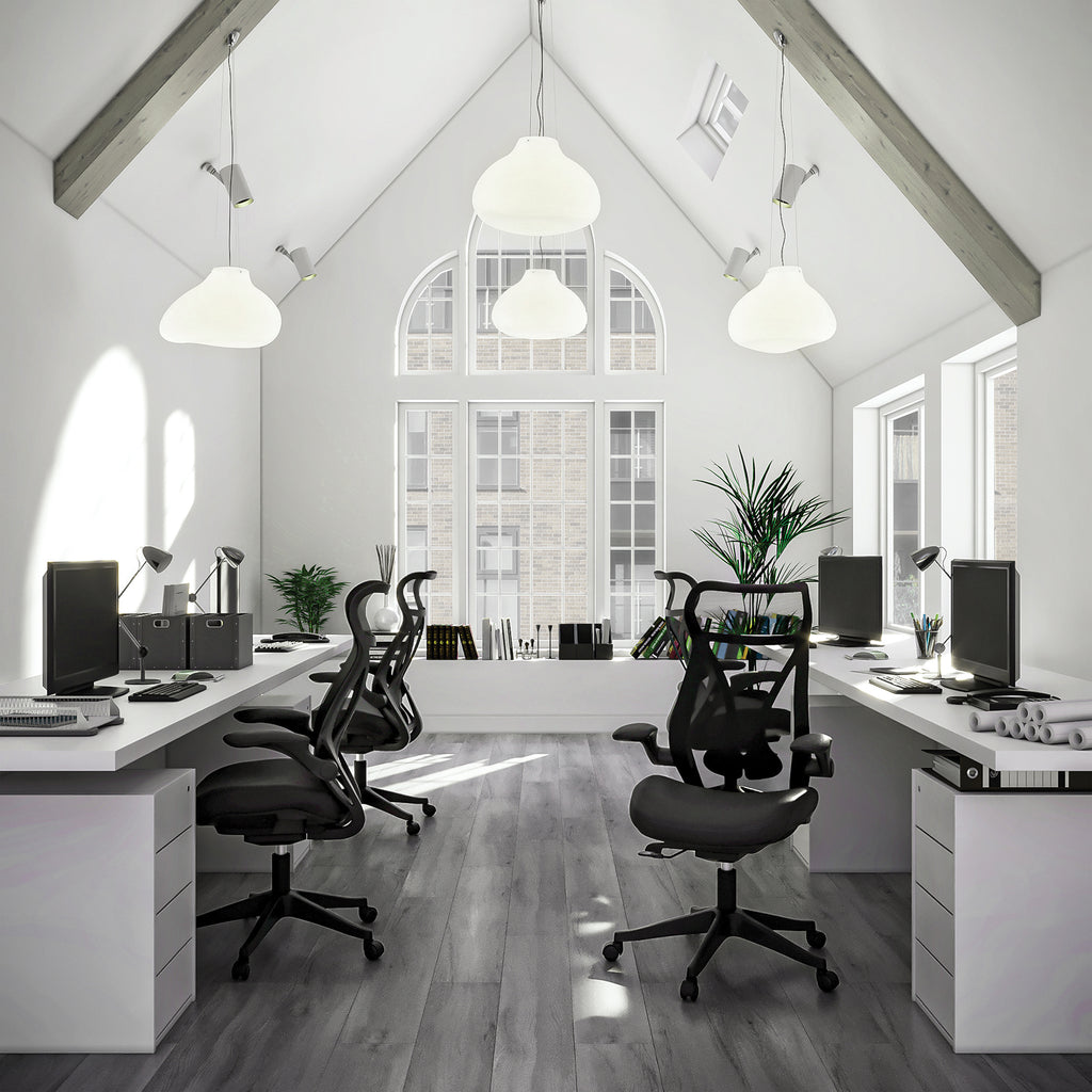 Modern office with white desks, black chairs, and large windows.