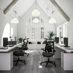 Modern office with white desks, black chairs, and large windows.