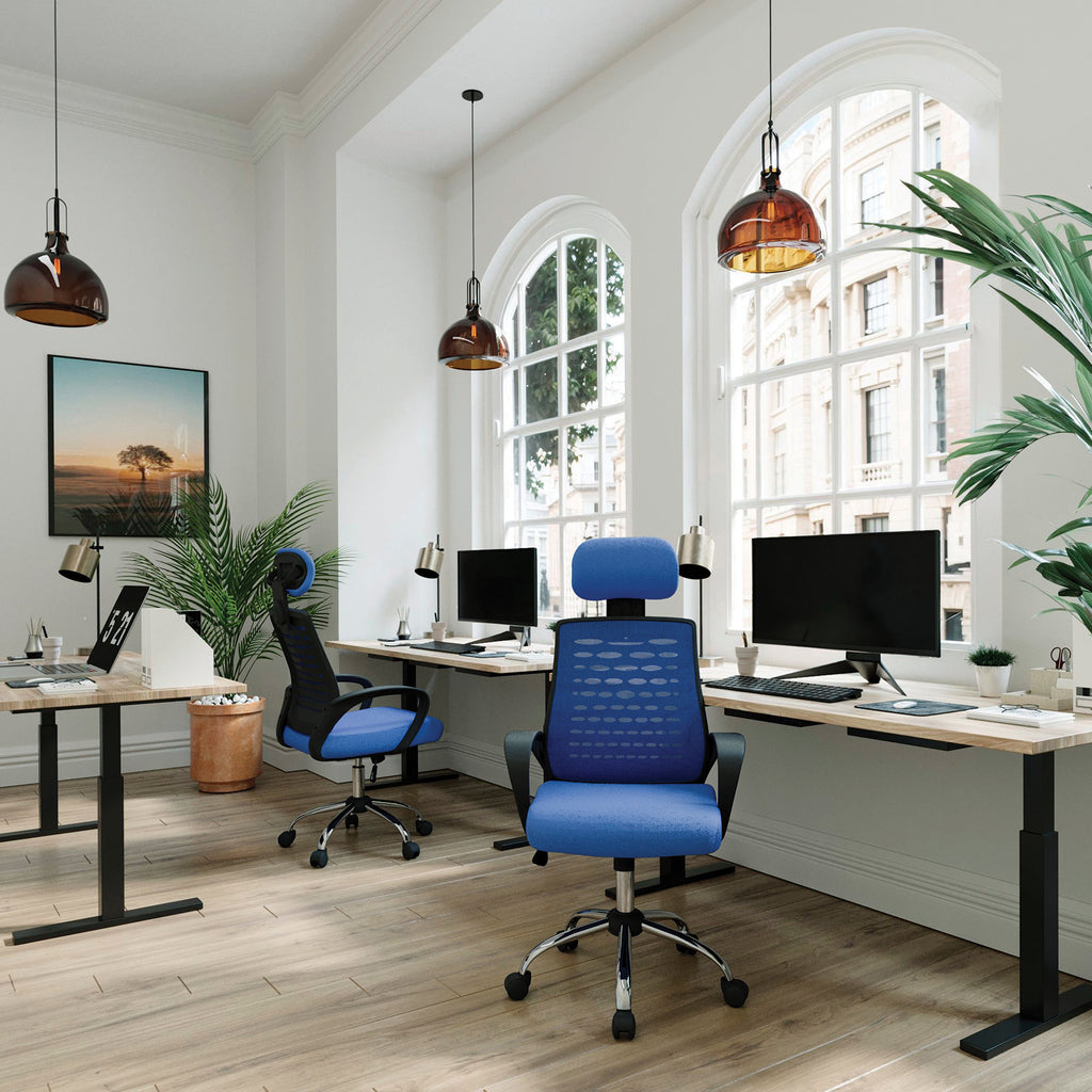 Modern office setup with blue chairs, desks, and large windows.