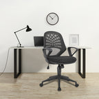 Modern office chair in front of a desk with a laptop and lamp, on a light wood floor.