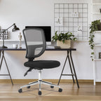 Black office chair in front of a desk with a computer and decor items.