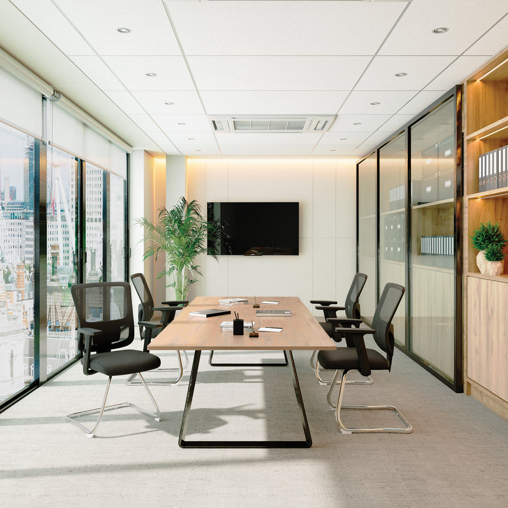 Modern conference room with a large table, chairs, and a TV on the wall.