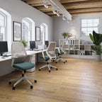 Modern office space with desks, chairs, and bookshelves.