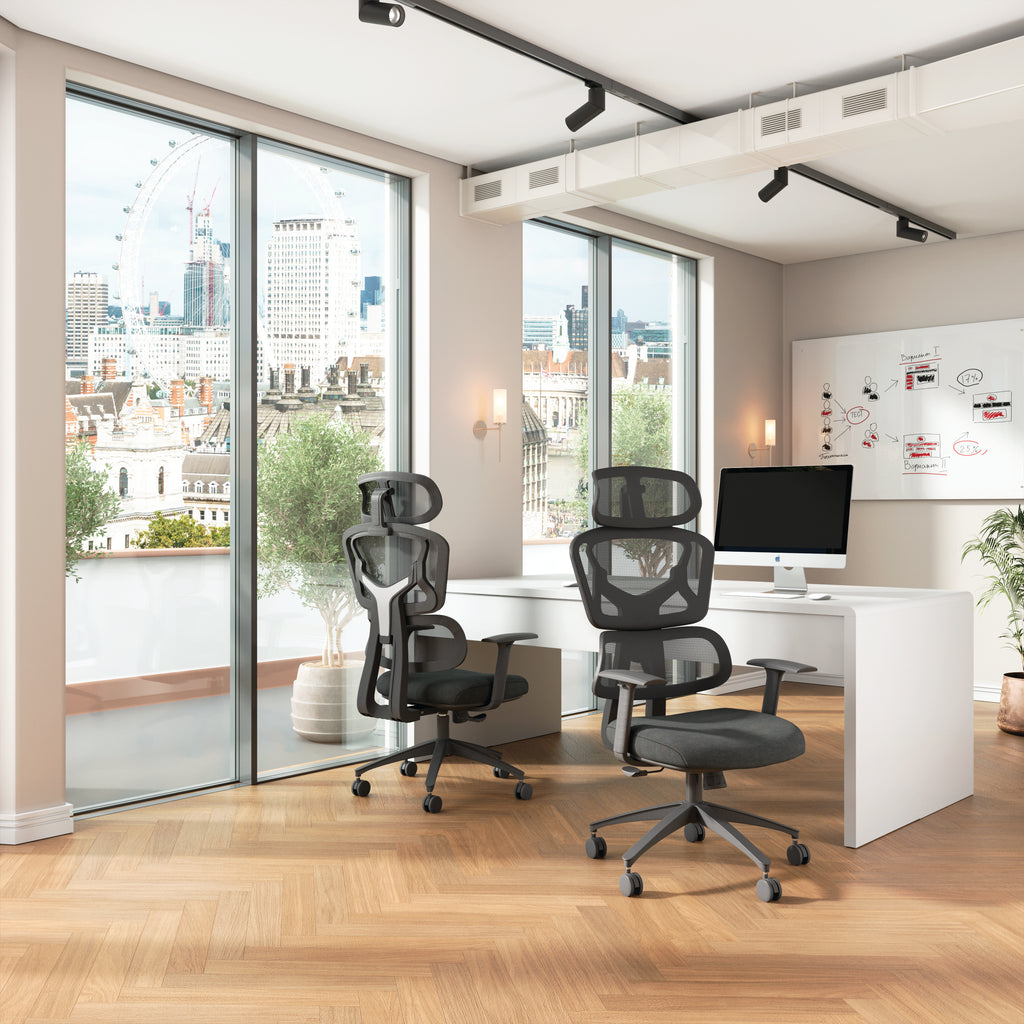 Modern office space with ergonomic chairs, a desk, and city view.