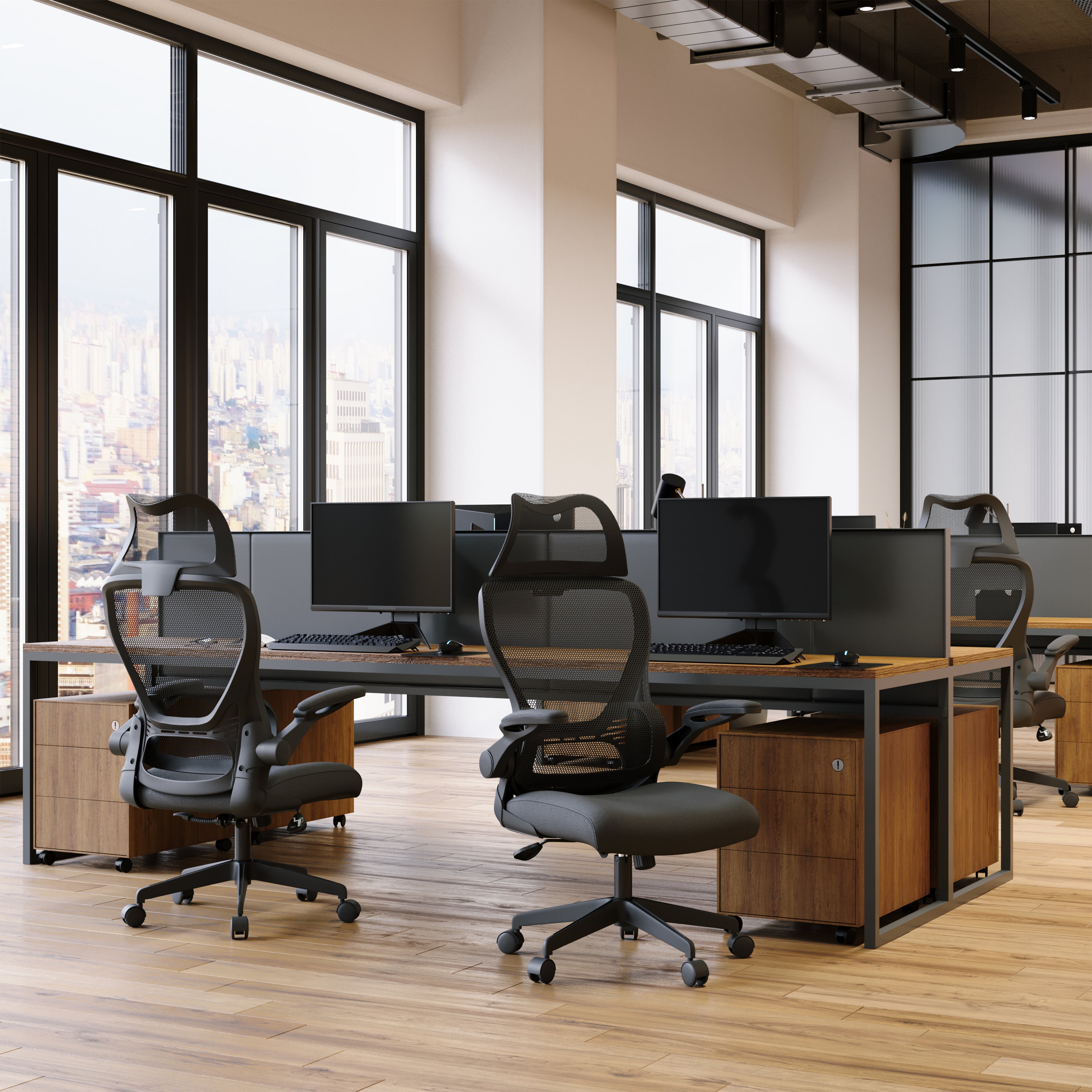Modern office with desks, chairs, and large windows overlooking a cityscape.