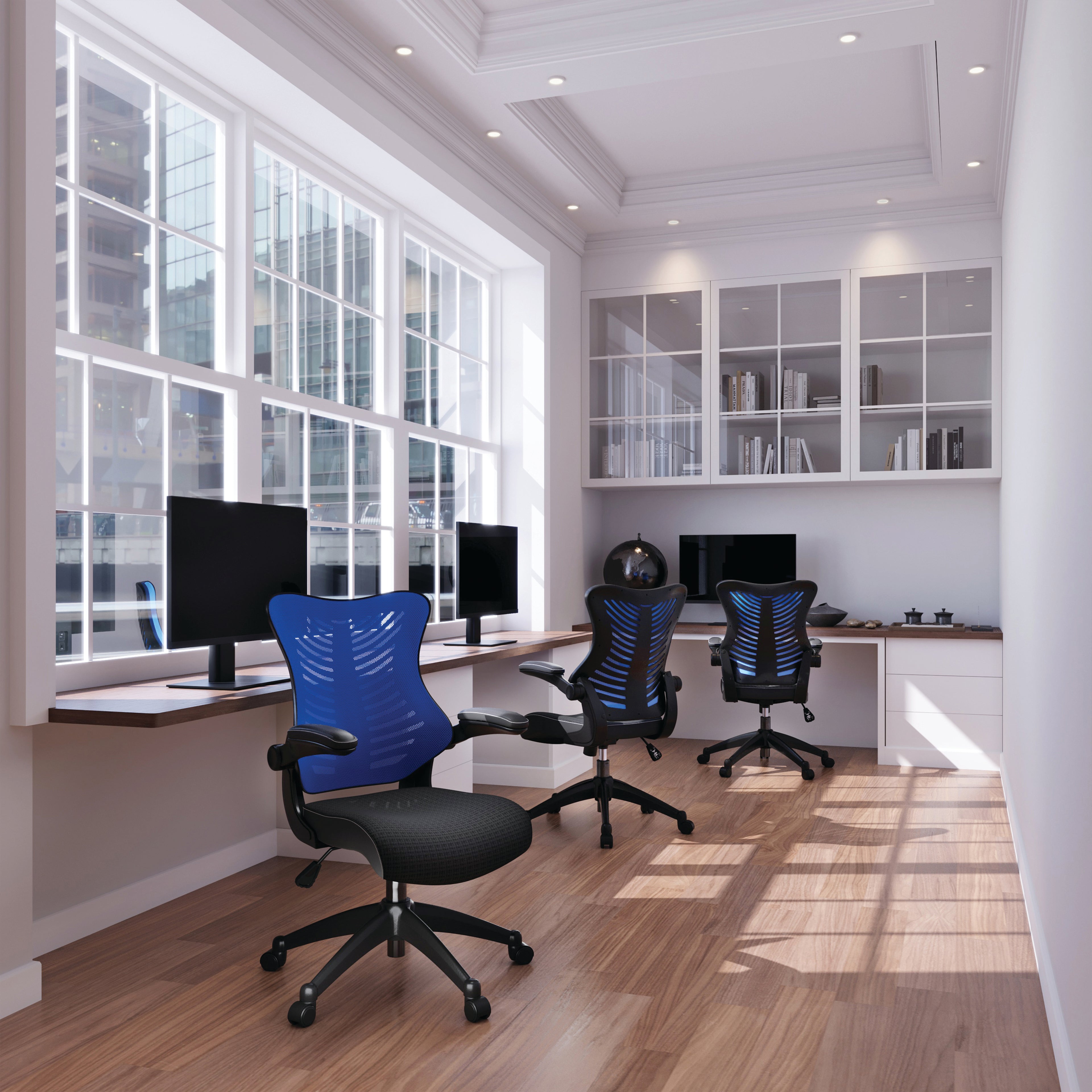 Modern office with blue and black chairs, multiple monitors, and large windows.