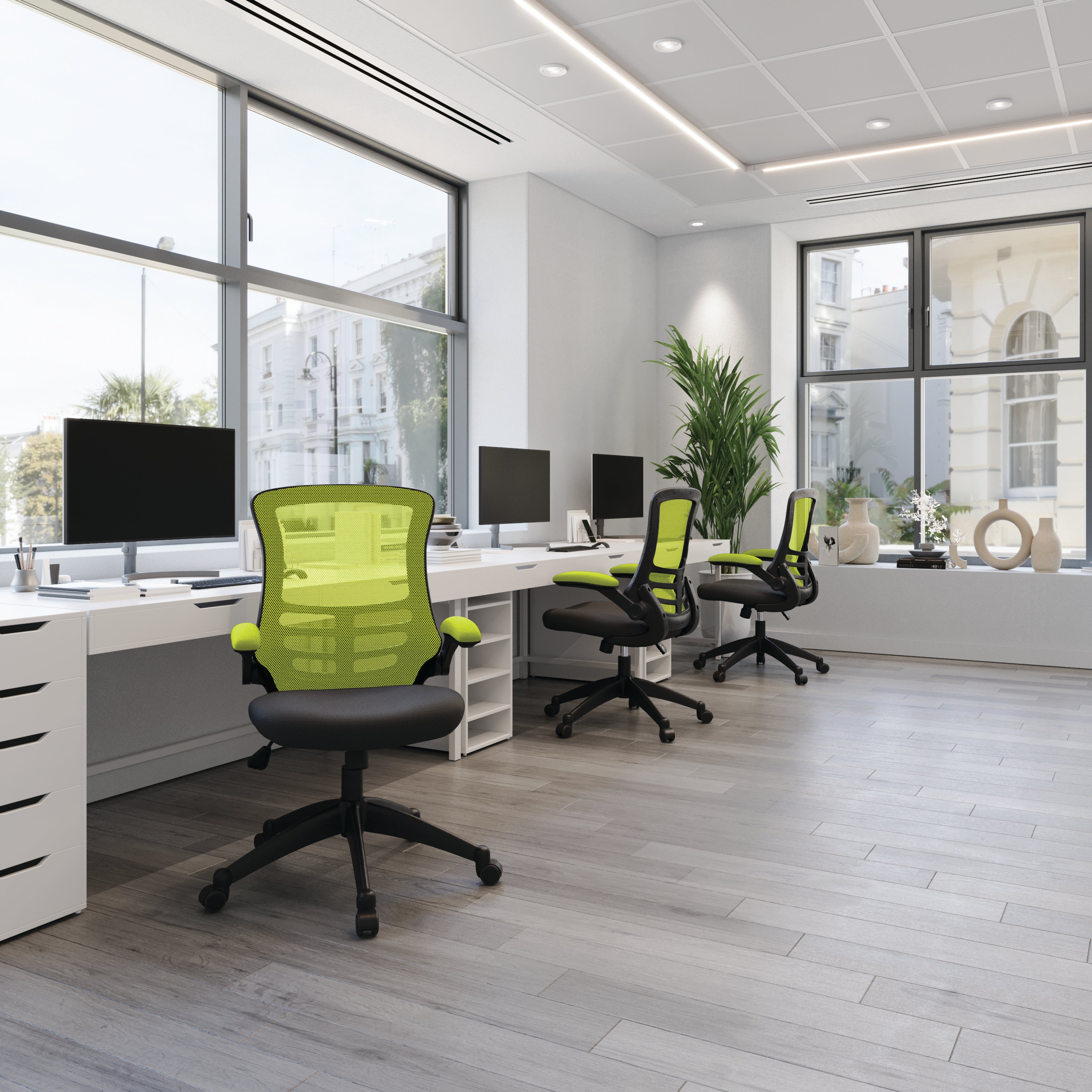 Modern office with green chairs and white desks