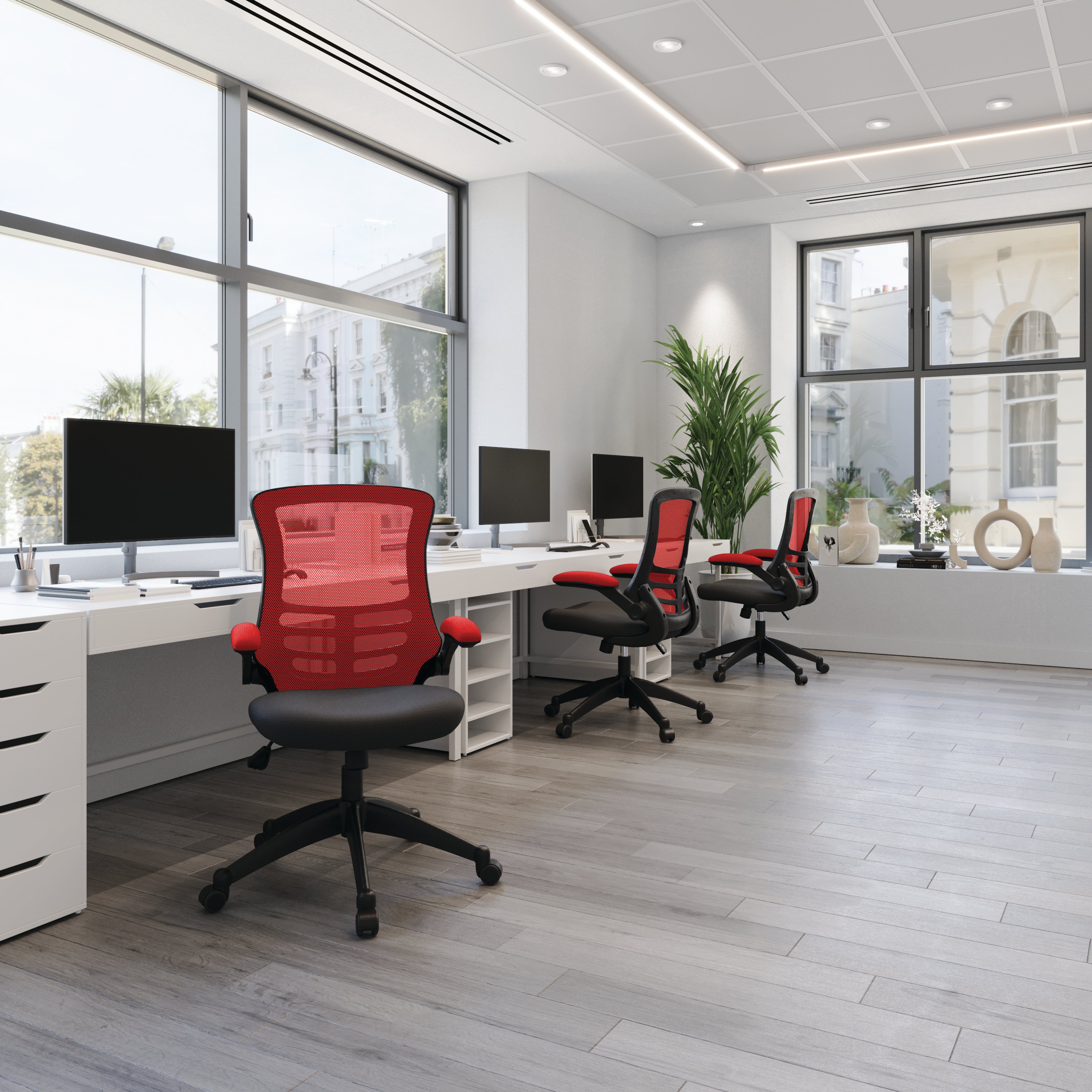 Modern office with red chairs and white desks