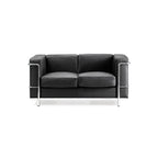Black leather sofa with chrome frame on a white background
