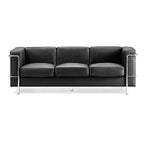 Black leather sofa with chrome frame on a white background