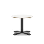 Small round table with white top and black metal frame on a white background