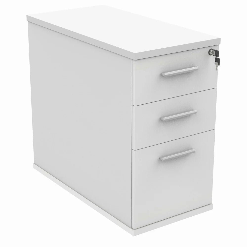 White pedestal with three drawers on a white background