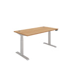 Height adjustable desk with wood-effect top and silver frame on a white background