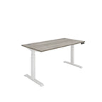 Height adjustable desk with grey wood-effect top and white frame on a white background