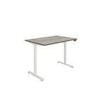 Height adjustable desk with grey wood-effect top and white frame on a white background
