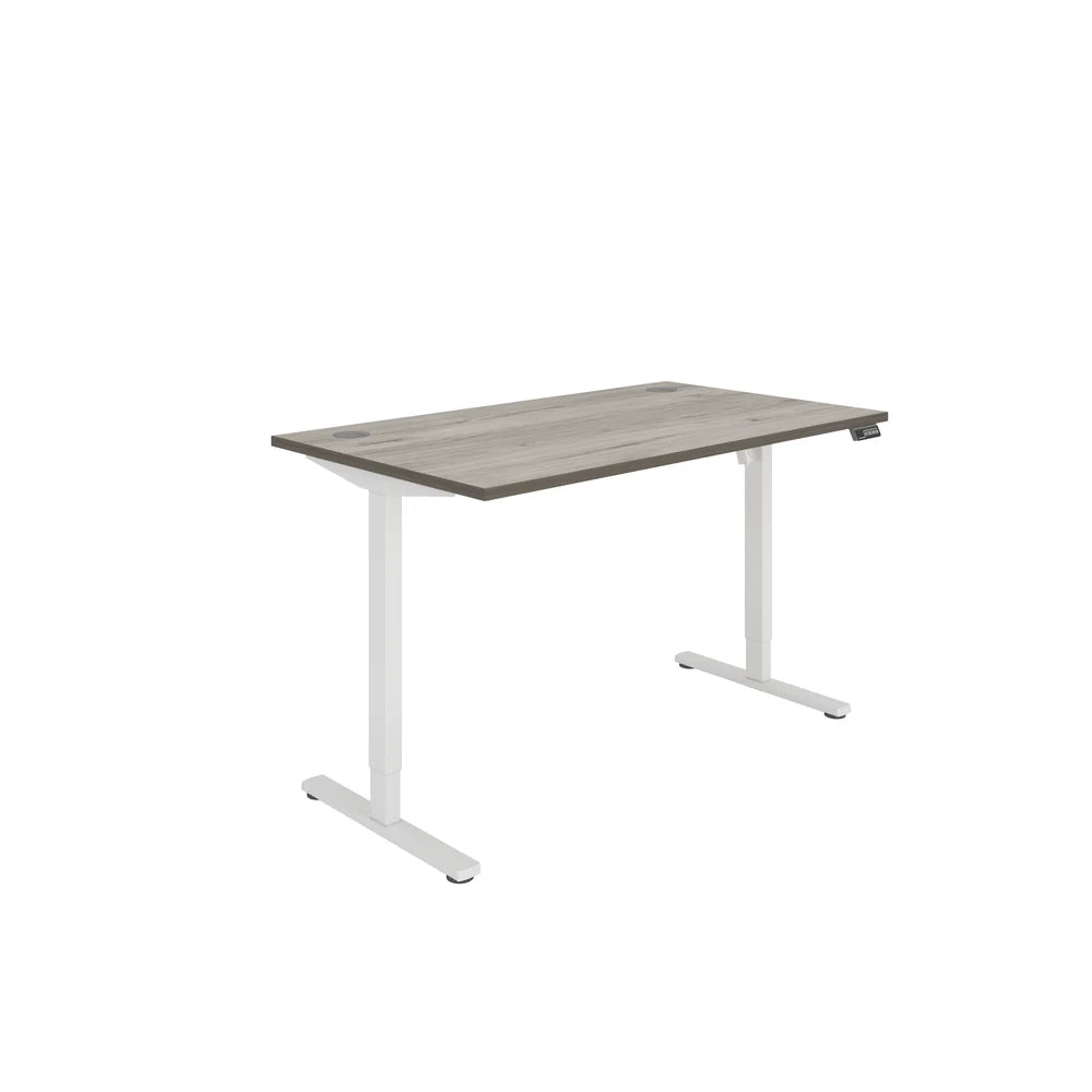 Height adjustable desk with grey wood-effect top and white frame on a white background