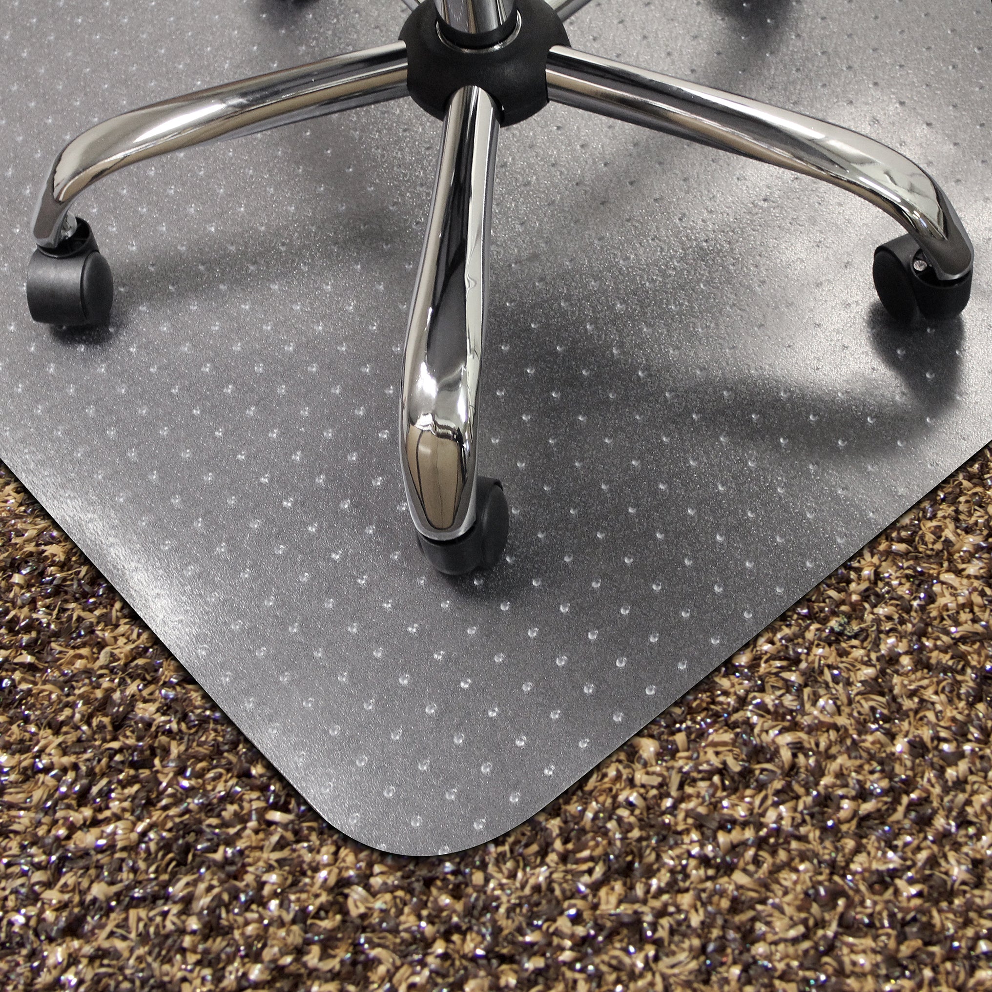 Grey office chair mat on a carpeted floor with a chair wheel visible.