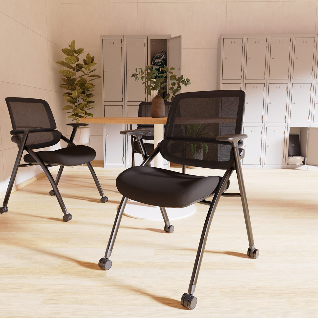 Black mesh office chairs with wheels in a modern office setting.