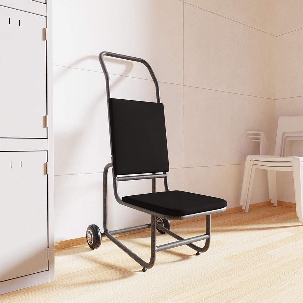 A black chair trolley with a metal frame and small caster wheels, shown in a clean indoor room with light wood flooring and cream walls.