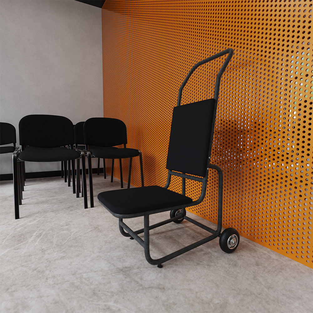 A black chair trolley with a tall curved backrest stands in front of a bright orange perforated metal wall, with additional black chairs lined up against a grey wall on a concrete floor.