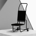 A modern black chair trolley with a high backrest and small wheels, shown on a white platform against a geometric grey background.