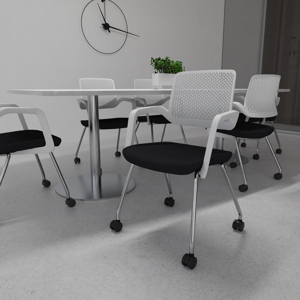 Black and white office chairs with metal legs next to a table with a clock and plants in the background
