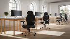 Modern office setup with ergonomic chairs and computer monitors.