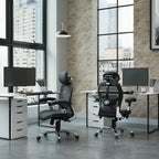 Modern office setup with two ergonomic chairs and desks in a large windowed room.