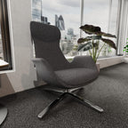 Modern high-back grey chair with metal frame shown in a office setting with windows and plants in the background