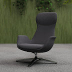 Modern high-back grey chair with metal frame shown in a room setting with green wall and plants in the background