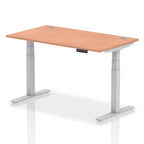 Adjustable height desk with wood-effect top and metal legs on a white background