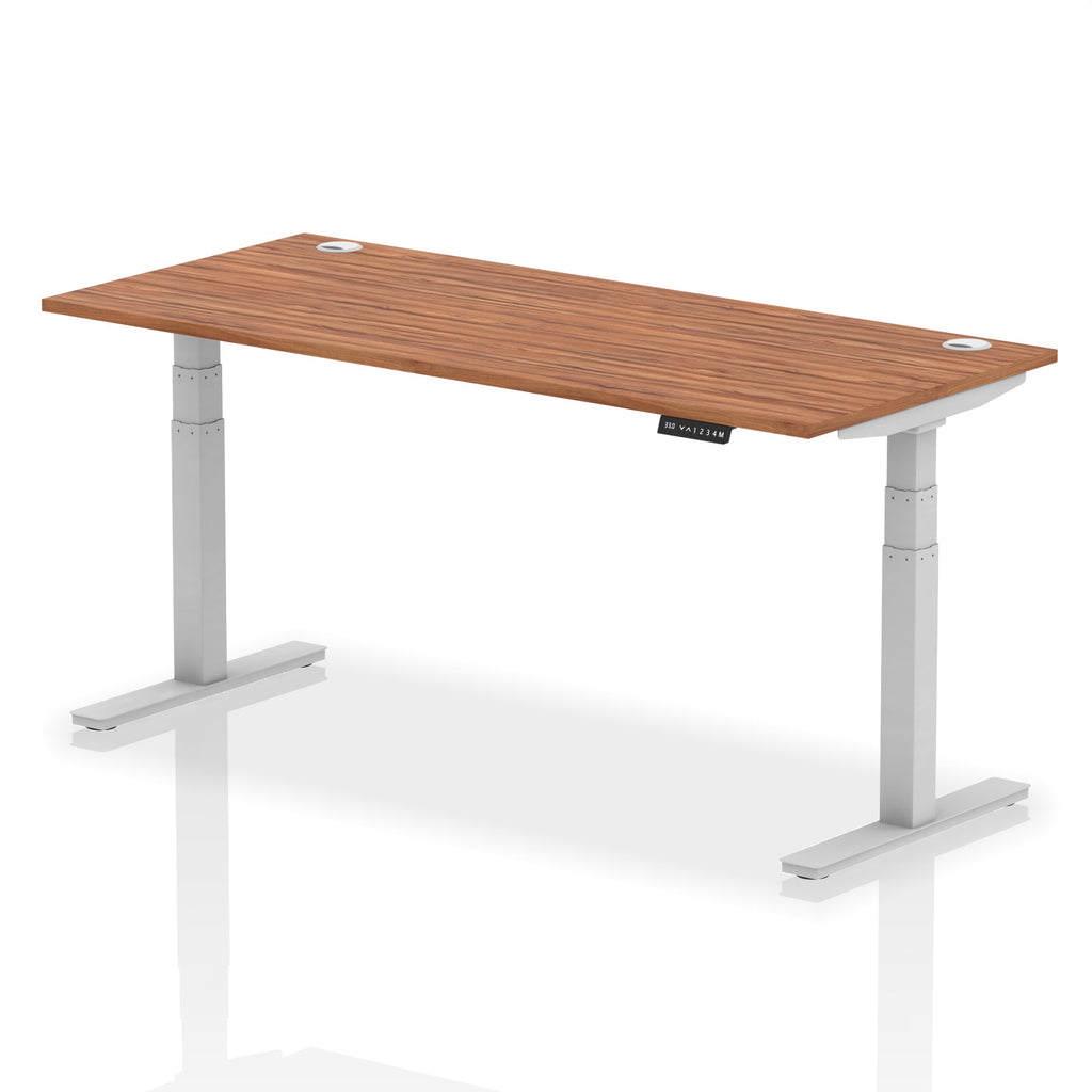 Adjustable height desk with wood-effect top and metal legs on a white background