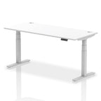 Adjustable height desk with white top and metal legs on a white background